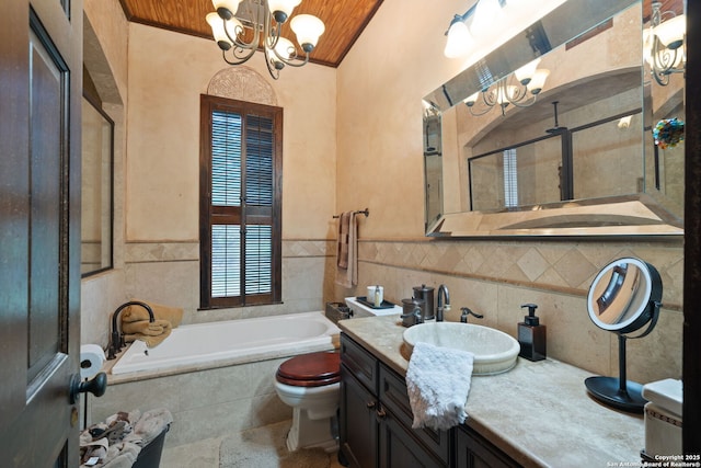 bathroom with tiled bath, lofted ceiling, a notable chandelier, toilet, and vanity