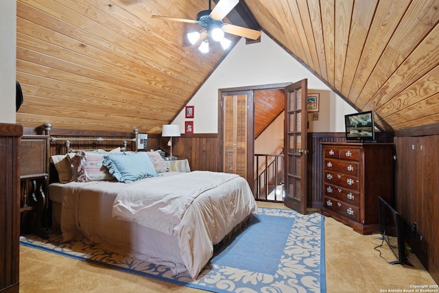 carpeted bedroom with wooden walls, lofted ceiling with beams, and wood ceiling