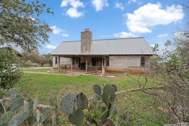 back of property featuring a lawn