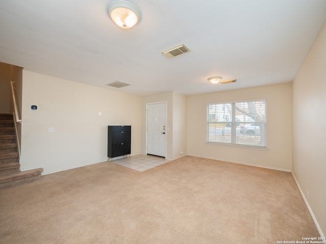 unfurnished living room with light colored carpet