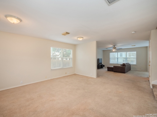 unfurnished living room with light colored carpet and ceiling fan