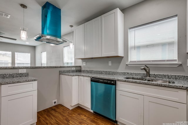 kitchen featuring pendant lighting, sink, island range hood, white cabinets, and stainless steel dishwasher