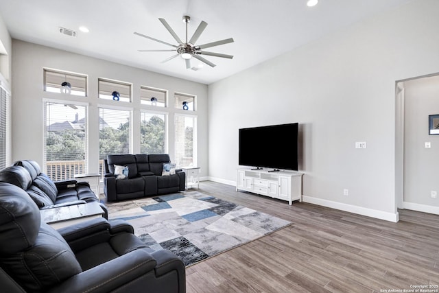 living room with hardwood / wood-style flooring and ceiling fan