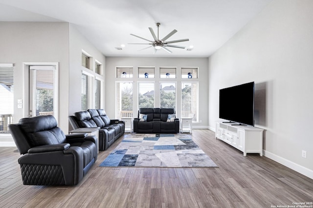 living room featuring ceiling fan and hardwood / wood-style floors