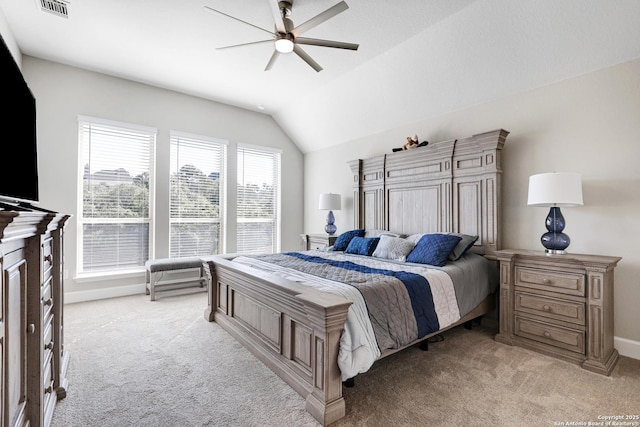 carpeted bedroom with vaulted ceiling and ceiling fan