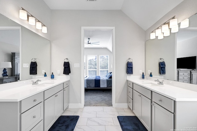 bathroom featuring ceiling fan, lofted ceiling, and vanity