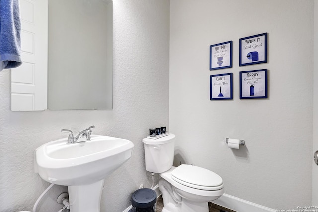 bathroom with hardwood / wood-style flooring and toilet