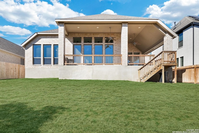 back of house with a yard and ceiling fan