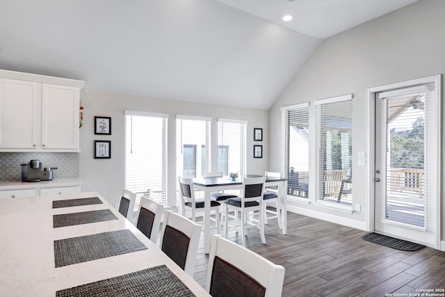 dining area with vaulted ceiling and dark hardwood / wood-style floors