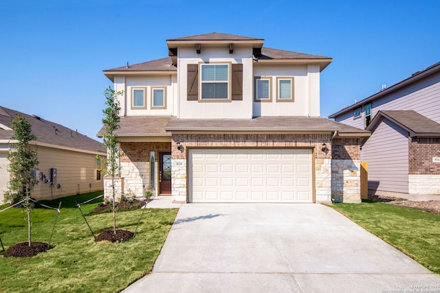 view of front facade with a garage and a front yard