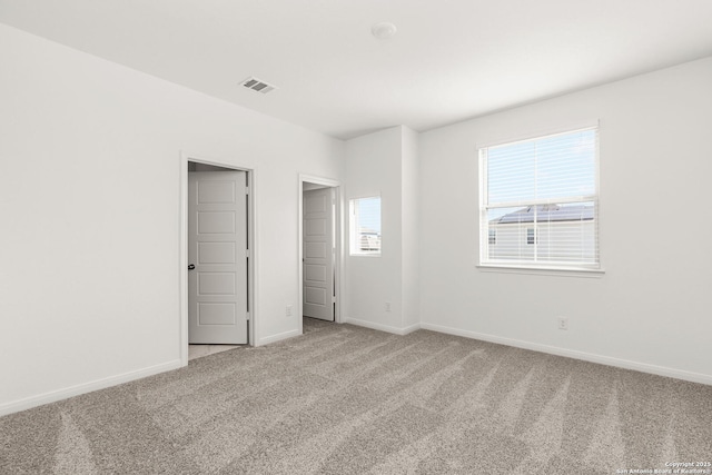 unfurnished bedroom featuring light carpet