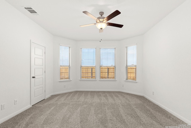 carpeted spare room featuring ceiling fan