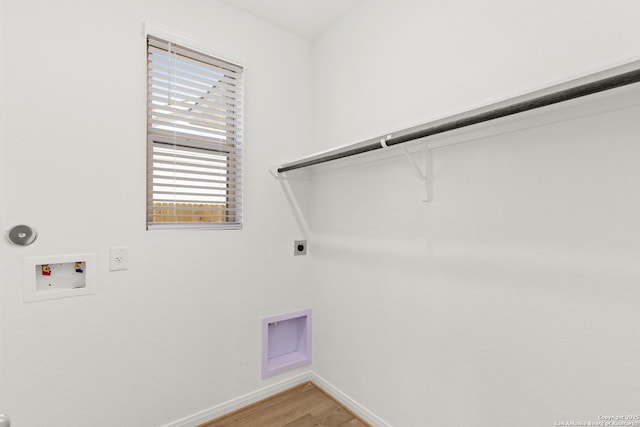 clothes washing area with hookup for a washing machine, gas dryer hookup, hardwood / wood-style flooring, and hookup for an electric dryer