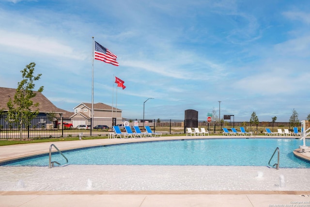 view of swimming pool with pool water feature