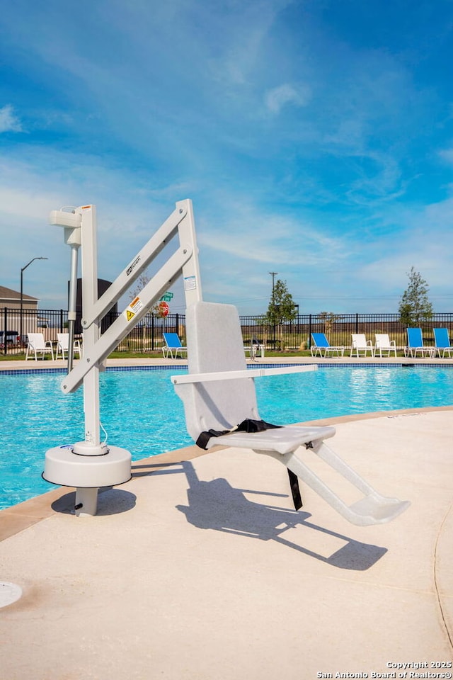 view of swimming pool with a patio area