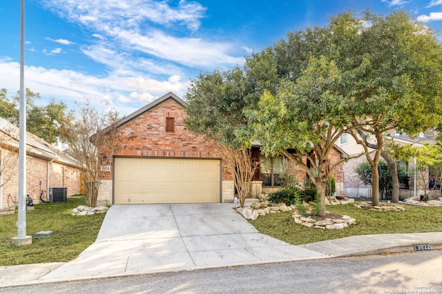 view of property with a garage, central AC, and a front lawn