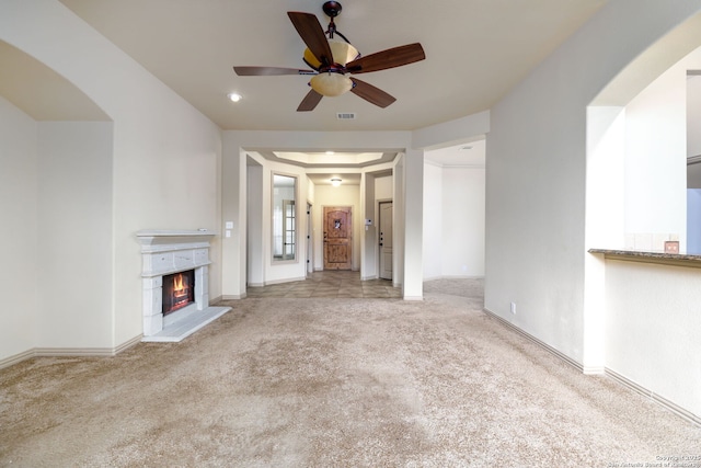 unfurnished living room with ceiling fan and light colored carpet