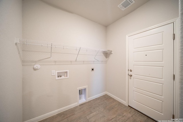 clothes washing area with washer hookup, hookup for a gas dryer, wood-type flooring, and electric dryer hookup