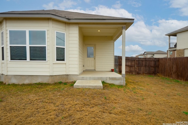 rear view of property with a lawn