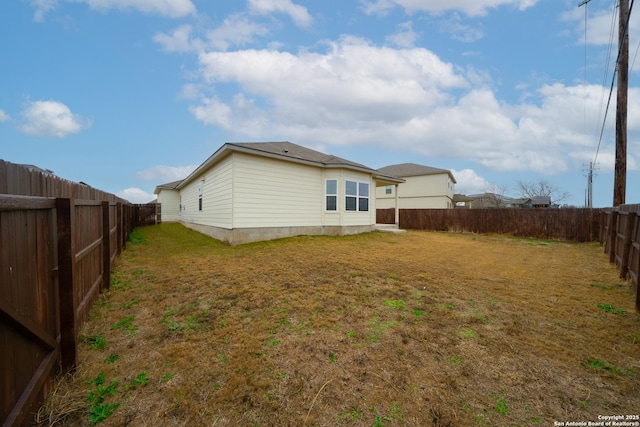 rear view of property with a lawn