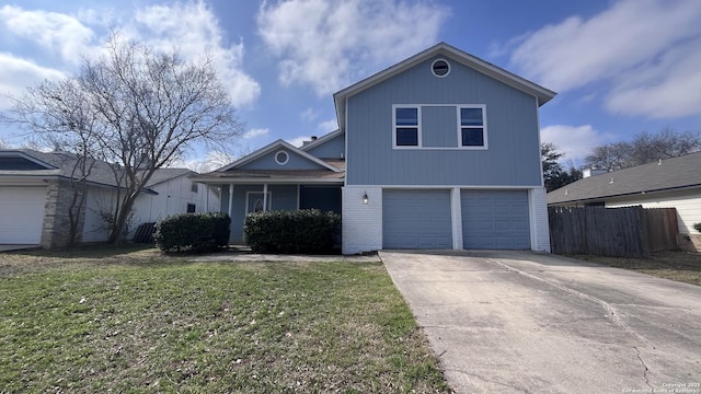 view of property featuring a garage and a front lawn