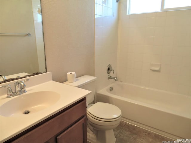 full bathroom with tiled shower / bath combo, vanity, tile patterned floors, and toilet