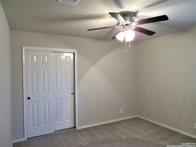 empty room featuring ceiling fan and carpet flooring