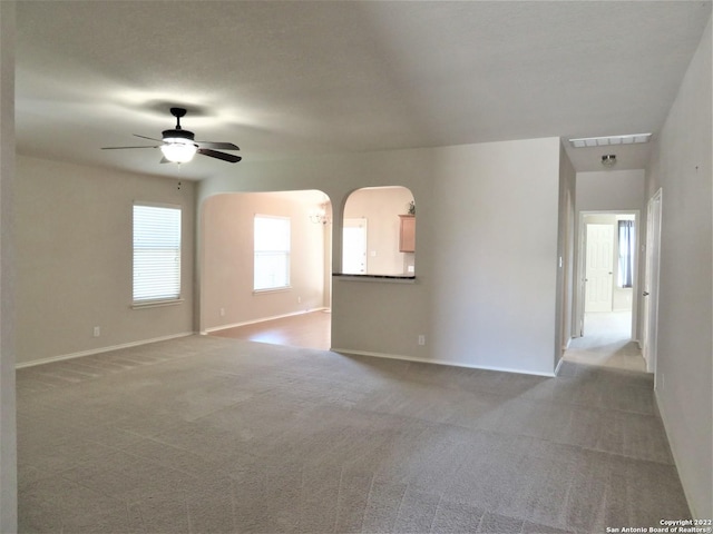 carpeted spare room featuring ceiling fan