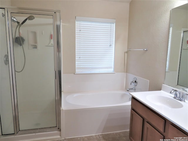 bathroom with vanity and separate shower and tub