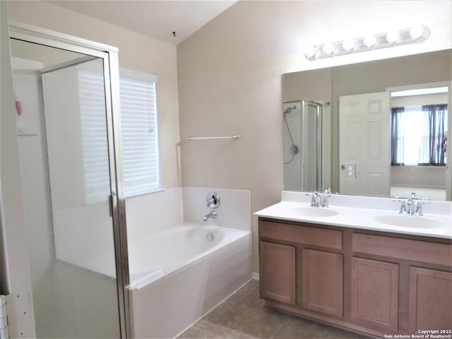 bathroom featuring vanity, shower with separate bathtub, and tile patterned flooring