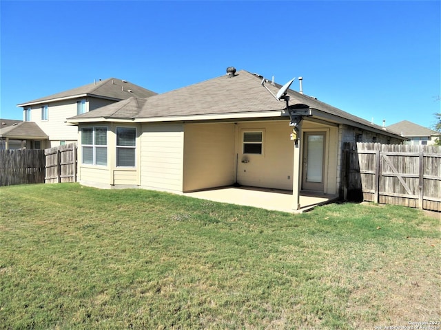 back of property featuring a yard and a patio