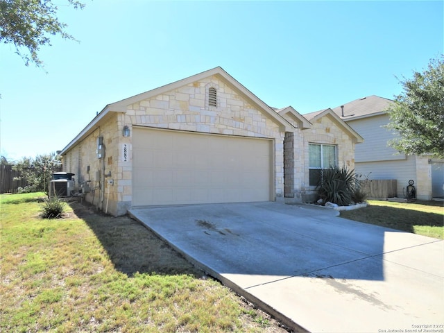 ranch-style home featuring a garage and a front lawn