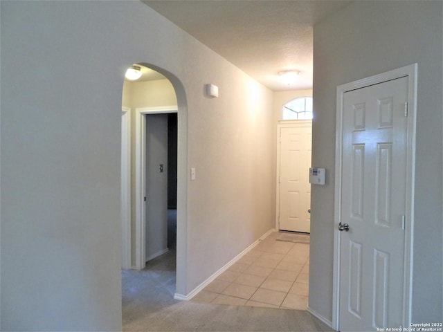 corridor with light tile patterned floors