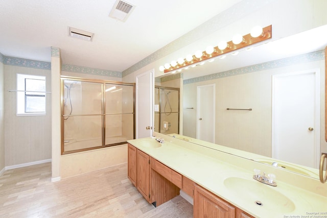 bathroom featuring vanity and combined bath / shower with glass door