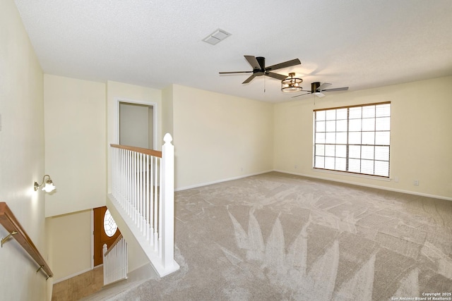 empty room featuring light carpet and a textured ceiling