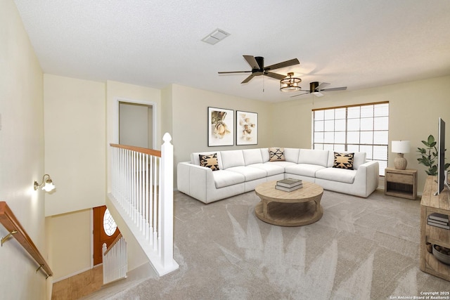 carpeted living room with a textured ceiling