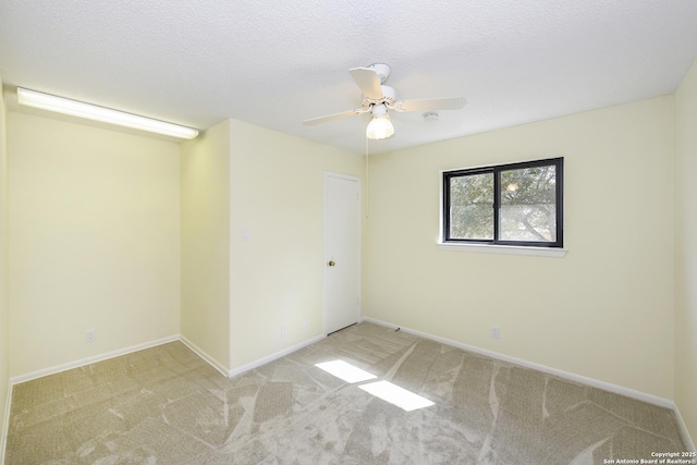 unfurnished room featuring light carpet, ceiling fan, and a textured ceiling