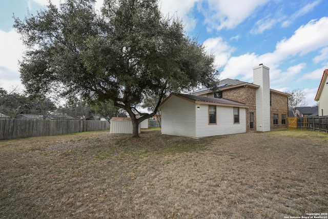 exterior space featuring a lawn and a storage unit