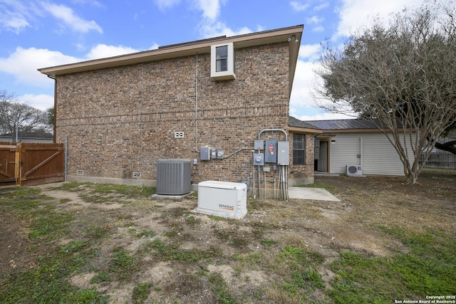 rear view of property with ac unit and central AC unit