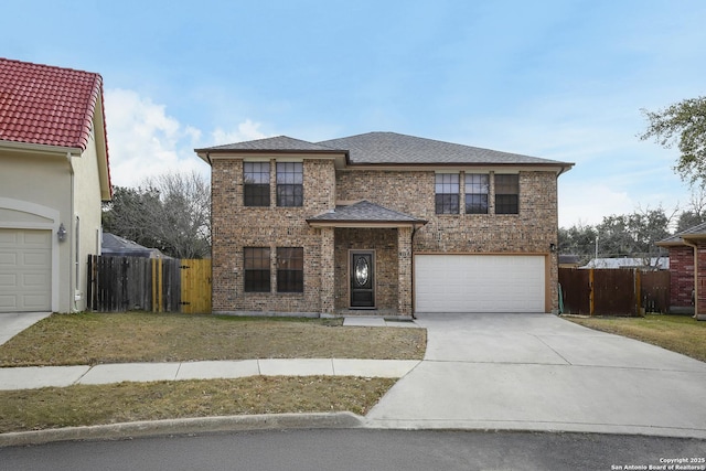 view of front of property featuring a garage and a front yard