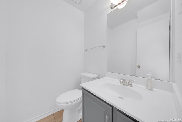 bathroom featuring vanity, wood-type flooring, and toilet