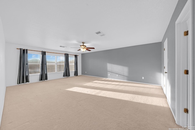 empty room featuring carpet flooring and ceiling fan