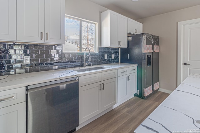 kitchen featuring sink, white cabinetry, appliances with stainless steel finishes, dark hardwood / wood-style flooring, and backsplash