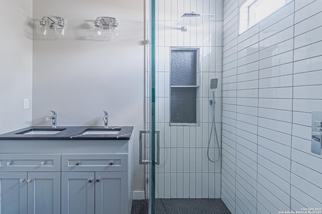 bathroom featuring vanity and a shower with shower door