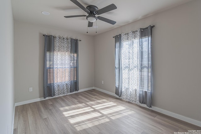 unfurnished room featuring ceiling fan and light wood-type flooring