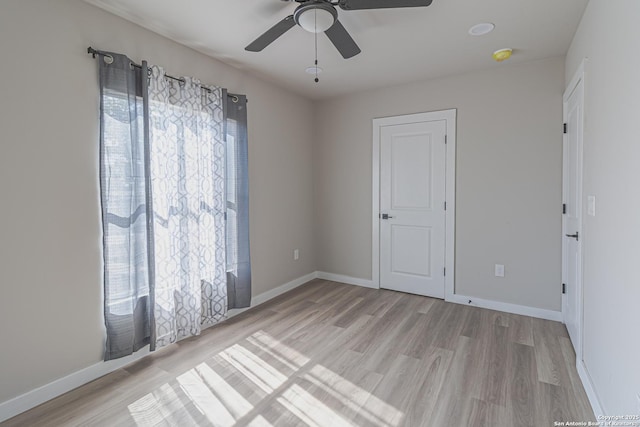 spare room with ceiling fan and light hardwood / wood-style flooring