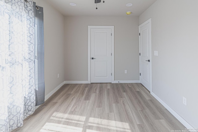 spare room featuring ceiling fan and light wood-type flooring