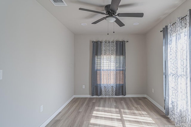 empty room with light hardwood / wood-style flooring and ceiling fan