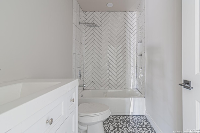 full bathroom featuring vanity, tiled shower / bath, tile patterned floors, and toilet