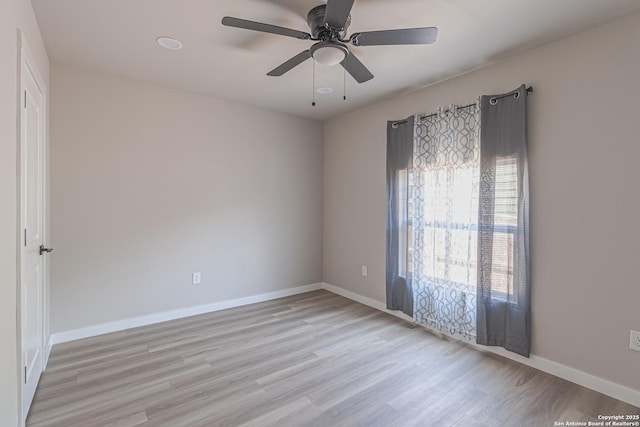 spare room with ceiling fan and light hardwood / wood-style flooring